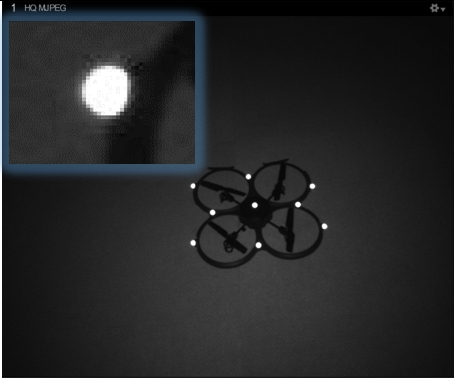 An image taken from an OptiTrack camera in MJPEG mode, with an inset close-up of a single marker.